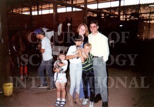 Marc and Claire with her family at a horseback riding stable in California