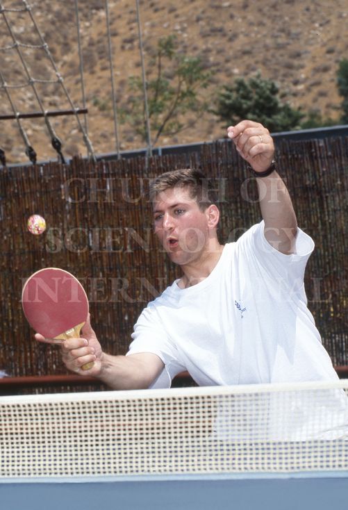 Marc playing a lively game of table tennis with colleagues at Golden Era